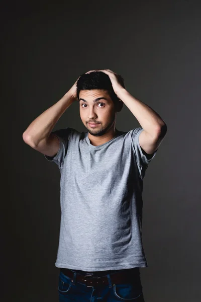 Portrait of a normal boy over grey background