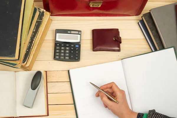 Businessman counting profit and losses, analyzing financial results