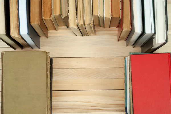 Pile of books. Hardback books on wooden table. Knowledge is important. Copy space.