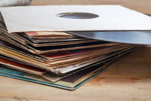 Vinyl record with copy space in front of a collection albums dummy titles, vintage process