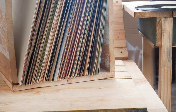 Vinyl record with copy space in front of a collection albums dummy titles, vintage process