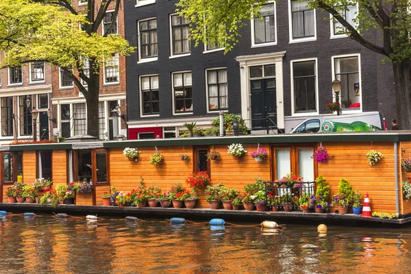 Traditional Dutch buildings and floating houses in Amsterdam, Ne