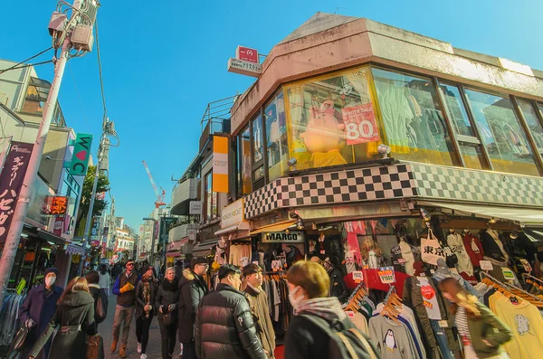 Tokyo, Japan - January 26, 2016: Crowds walk through Takeshita Street in the Harajuku . Tokyo , Japan