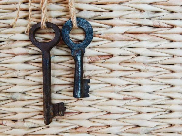 Two keys on a background of woven box