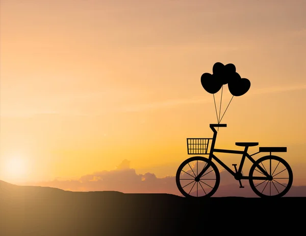 Silhouette of old bicycle with sunset