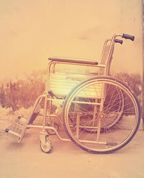 Vintage,Old Wheelchairs with wall background