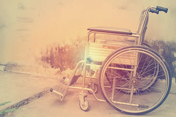 Vintage,Old Wheelchairs with wall background