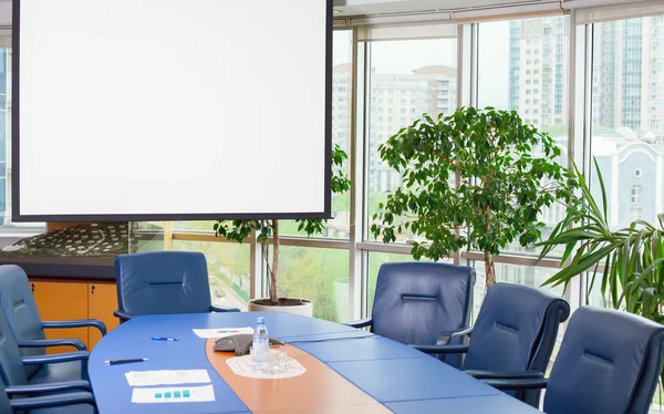 Empty meeting room with white screen