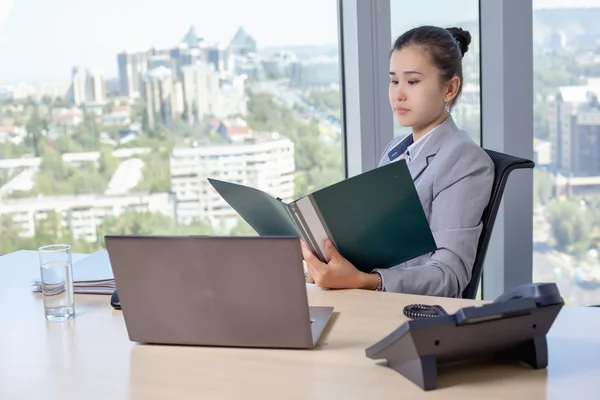 Young asian business woman with notebook in the office