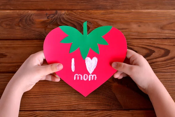 Child holds greeting card in his hands