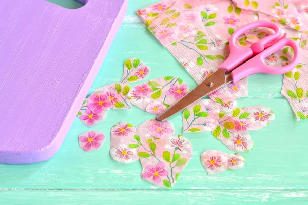 Decorative painted chopping board. Cut pieces of napkins. Scissors, flowers napkin fragments. Decoupage tutorial - decorating kitchen cutting board.