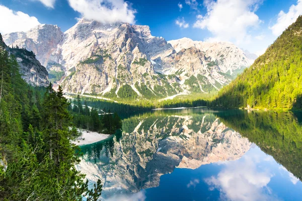 Lake Braies also known as Lago di Braies. The lake is surrounded by the mountains which are reflected in the water.
