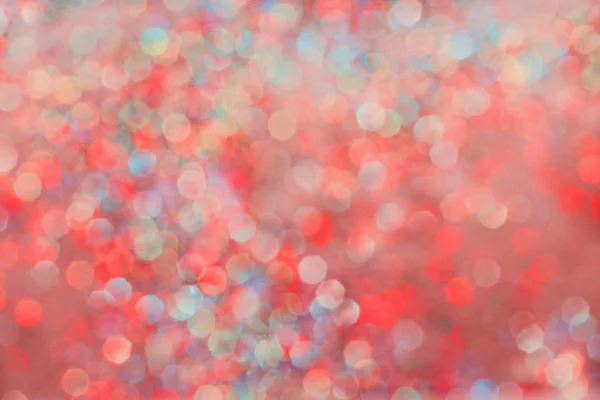 Red abstract glitter bokeh background. Defocused hexagon prism lights.