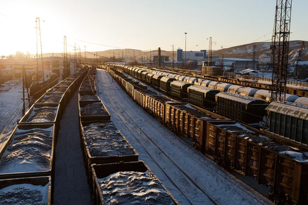 Freight trains with coal in the rays of the sun in Murmansk