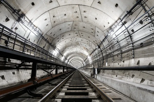 Straight circular subway tunnel with a white lighting