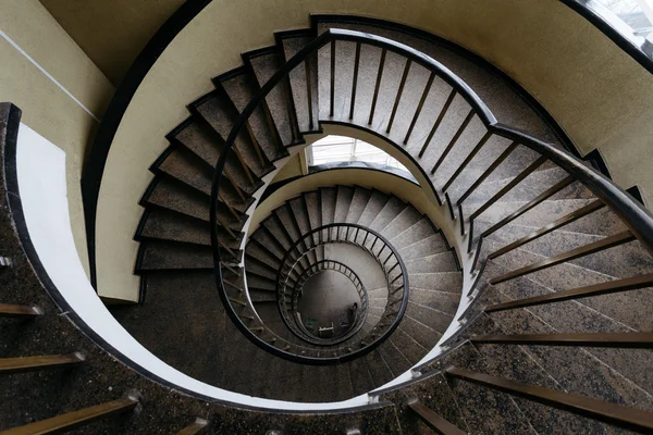 Spun circular staircase with a handrail in a building without people