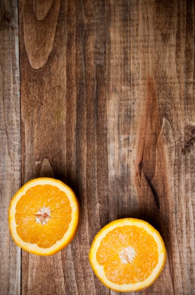Oranges cut in half on cutting board, view from above