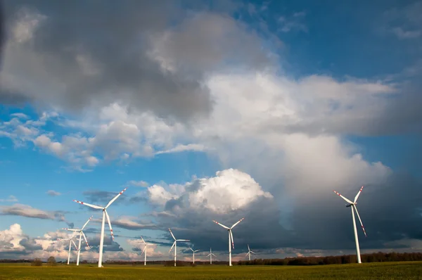 Wind turbines on the field before storm