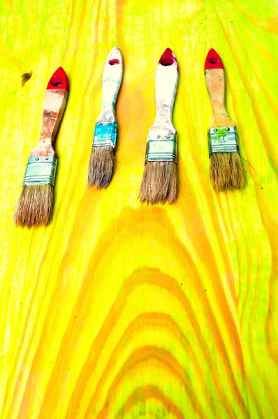 Painting brushes on green wooden table