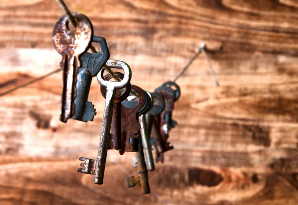 Old rusty keys hanging on a twine