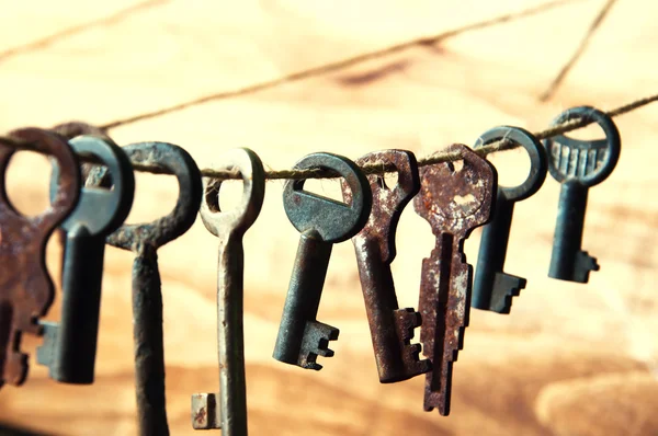 Old rusty keys hanging on a twine