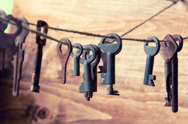Old rusty keys hanging on a twine
