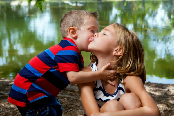 Little Brother Kisses Big Sister\'s Cheek
