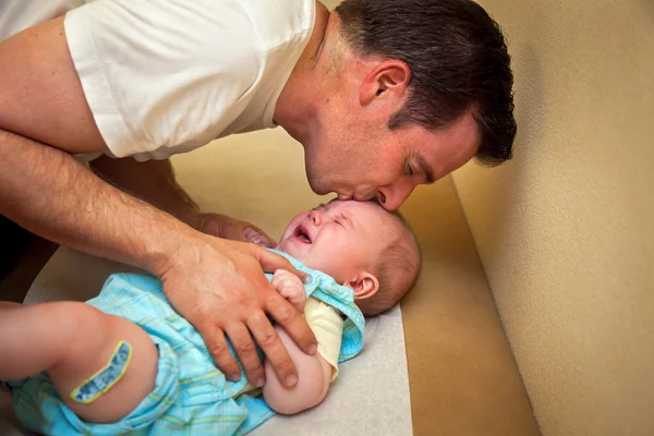 Father Comforts Vaccinated Son