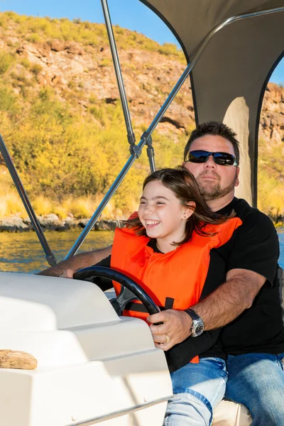 Father and Daughter Driving a Boat on a Desert Lake