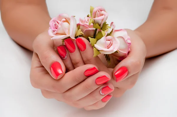 Red manicure with white roses and crystal