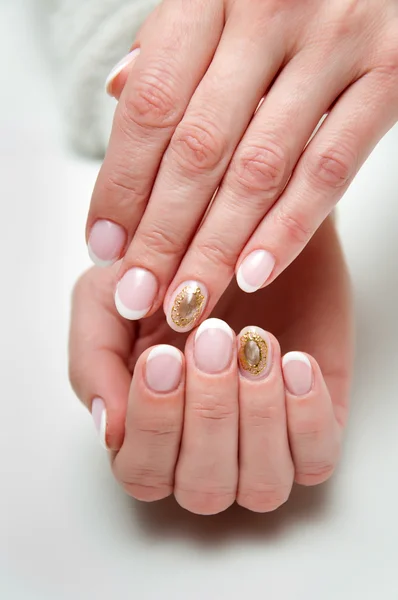 Wedding french manicure with liquid stone cameo brooch on the ring finger