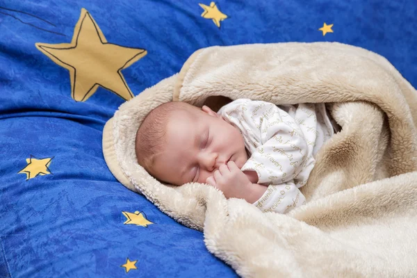 The baby is sleeping sweet dream on a blue pillow