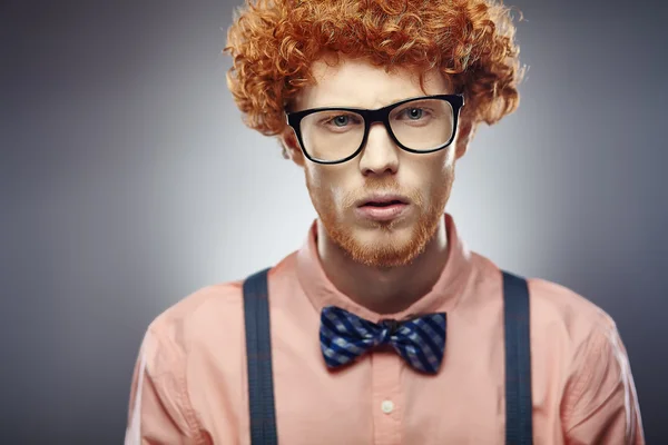 Young redhead curly bearded man