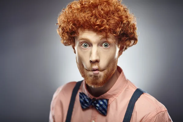 Young redhead curly bearded man