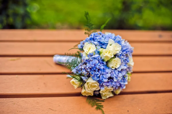 Bride\'s Wedding bouquet on the bench