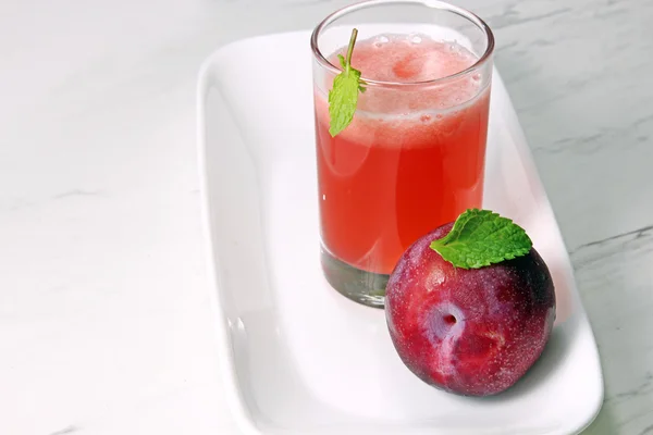A glass of plum juice