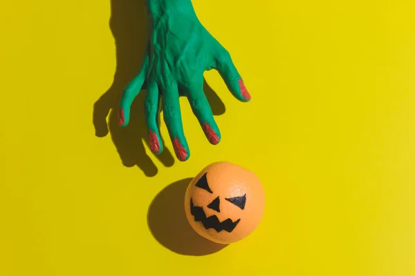 Creepy hand and Halloween jack o'lantern
