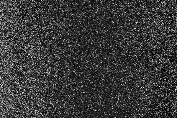 Black plastic texture background, close up