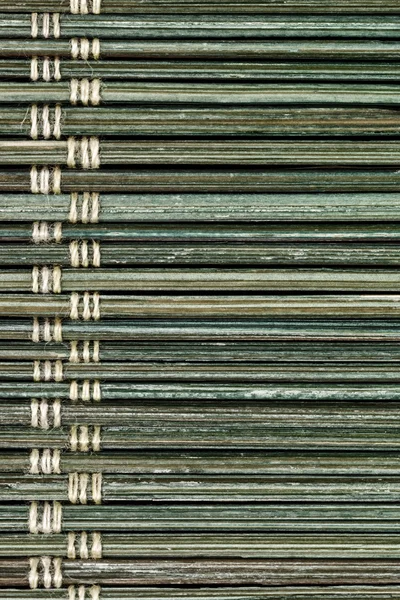 Old straw placemat texture background, close up