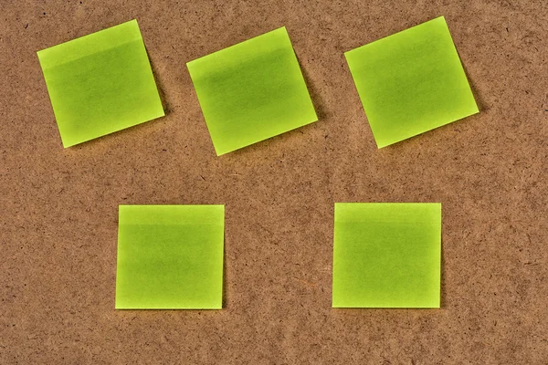 Yellow-green blank paper stickers on the old fibrous cardboard