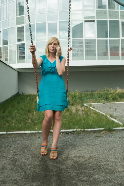 The girl with the phone on the street in the yard