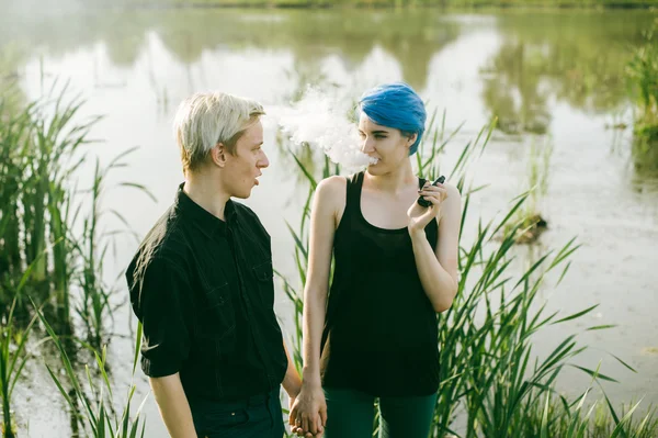Man and woman with dyed hair romantically spend time in nature. romantic couple in love outdoors