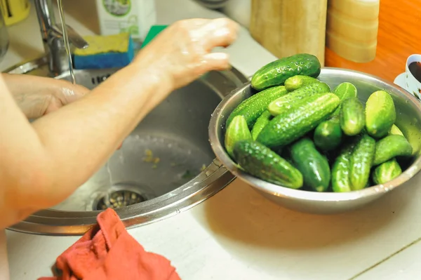 People are preparing in the kitchen. pickling cucumbers, preparation for winter salting.