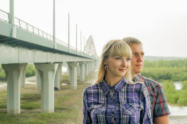 Man and woman in the plaid shirt, trousers and chert