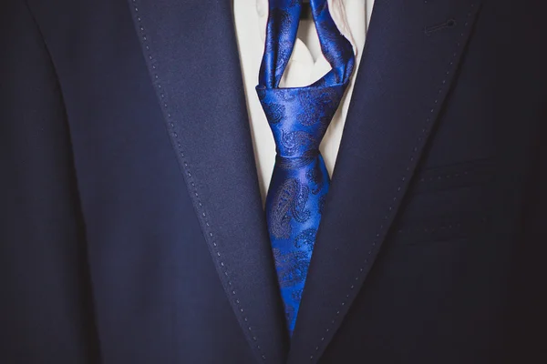 Fragment of the suit with a blue tie