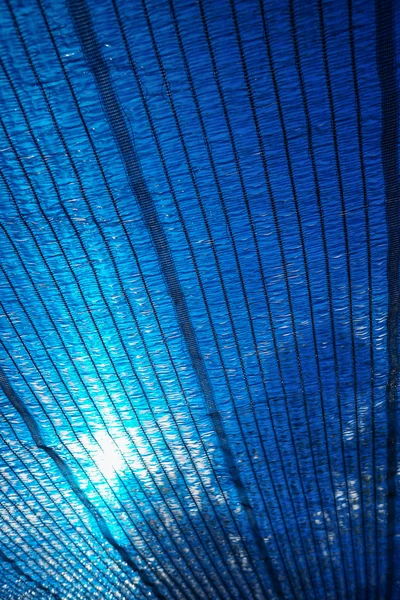 Sun Through a blue Shading net, plastic awning used as a sunshade