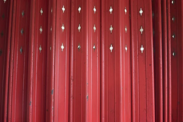 Close up Antique slide steel door, Old style of closed red steel door. little Rusty on steel door. Folding steel door texture pattern and background. Dark edged