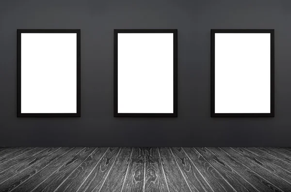 Three Black frame hanging on a grey wall, white isolate, included clipping path in a frame , perspective black wooden floor, for advertiser, graphic editor