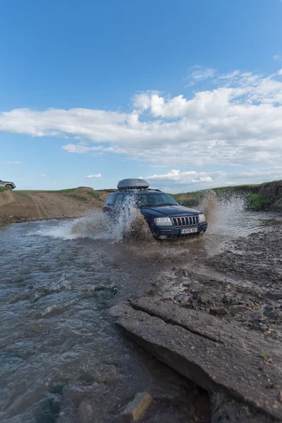 Off-road 4x4 contest in Dobrogea, Jeep Grand Cherokee splashing water in a river