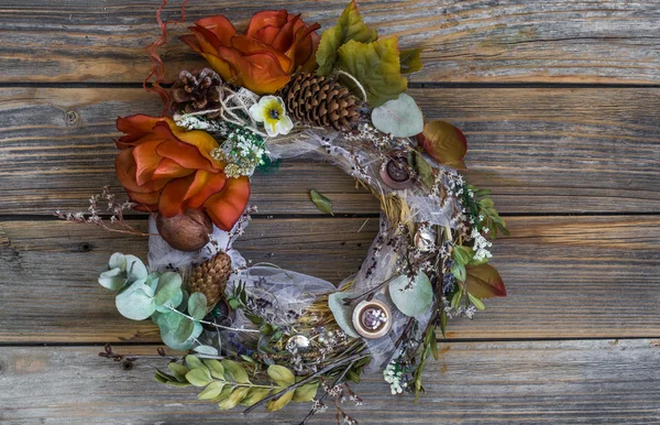 Autumn wreath on wooden background in the form of a circle